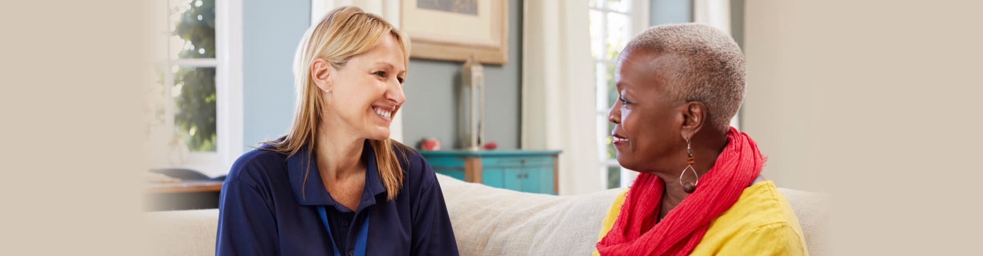 caregiver visits senior woman at home
